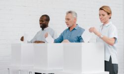 cheerful multicultural citizens voting while standing near boxes