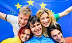 Young football supporter fans cheering with european flag