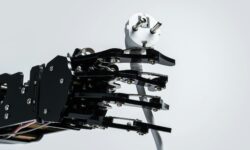 Real robotic hand with power plug. Concepts of AI takeover and Technological singularity